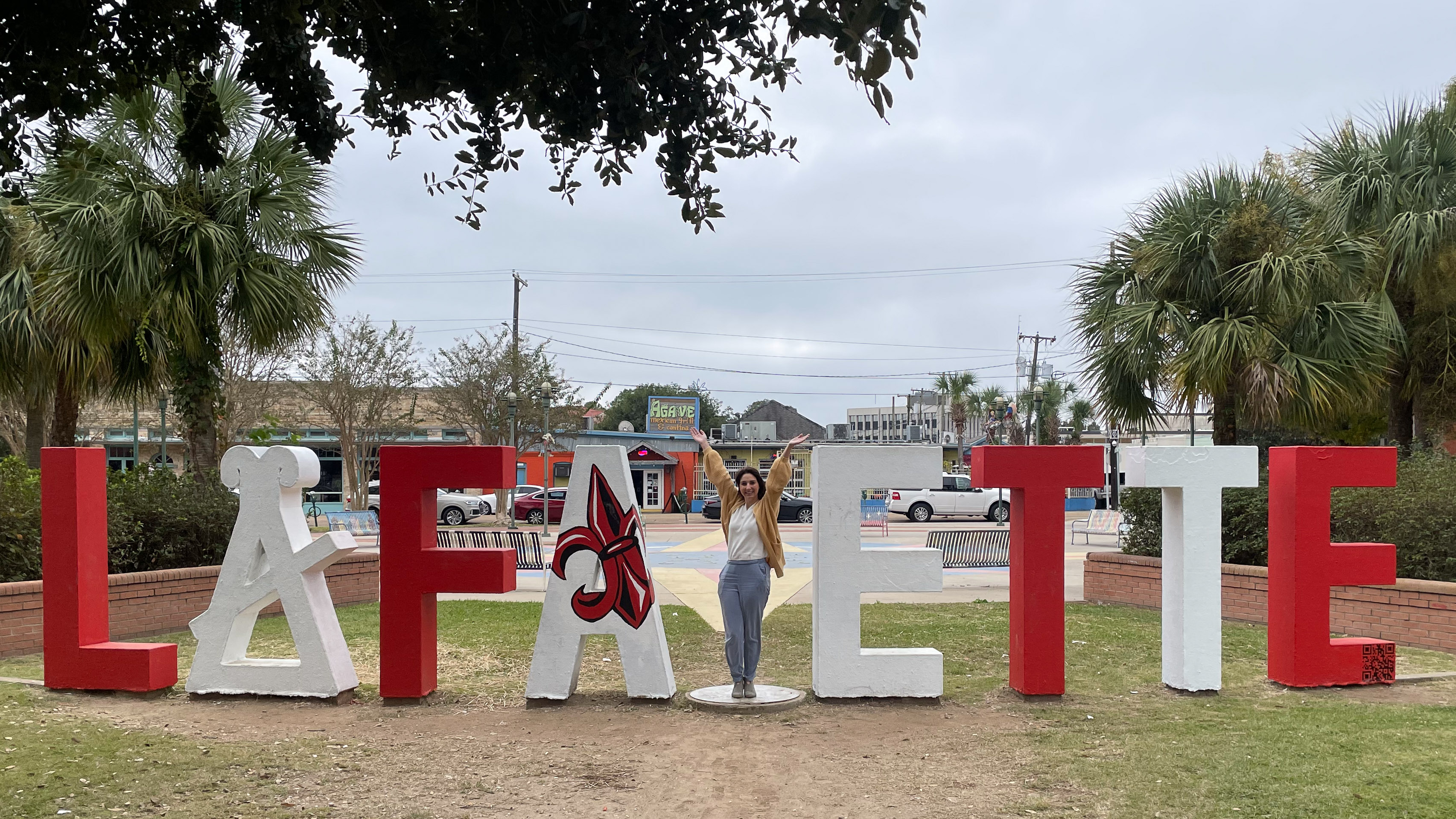 Lafayette letters in the park where person can stand in as the Y, painted for the Ragin Cajuns
