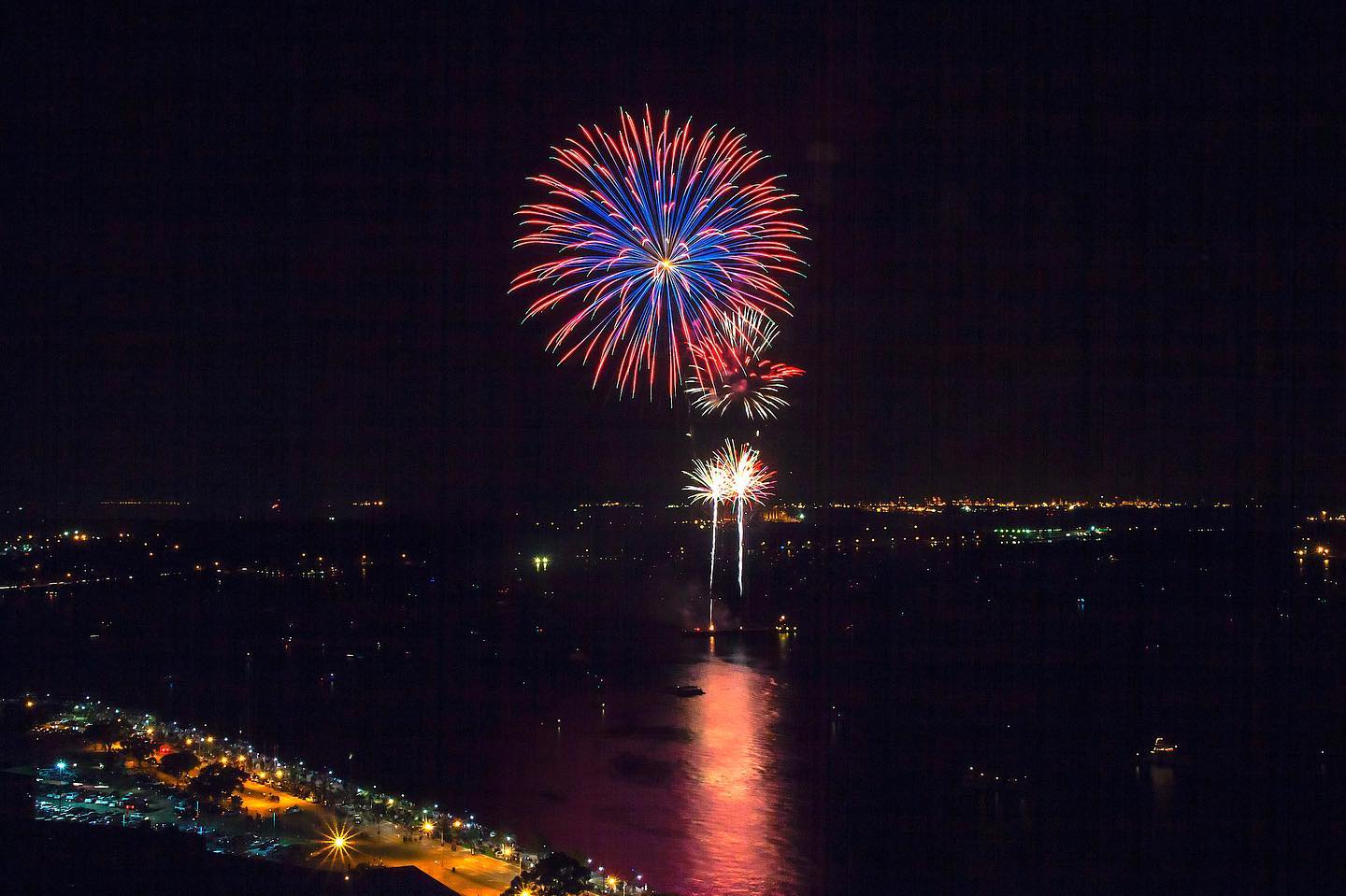 Fireworks cast a reflection onto a lakefront in Lake Charles, Louisiana.