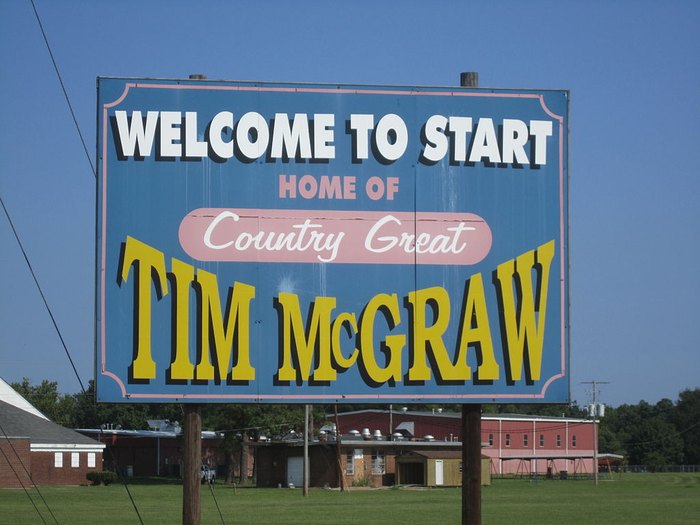 A sign says "Welcome to Start, home of Country Great Tim McGraw"