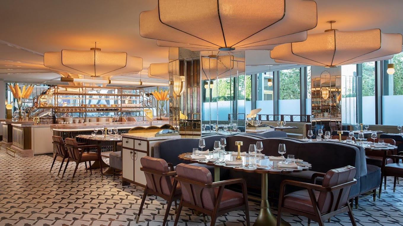 The interior of Miss River in New Orleans offers a chic, diner-esque vibe with black-and-white tiled floors, dimmed overhead lighting and mirrors behind the bar.