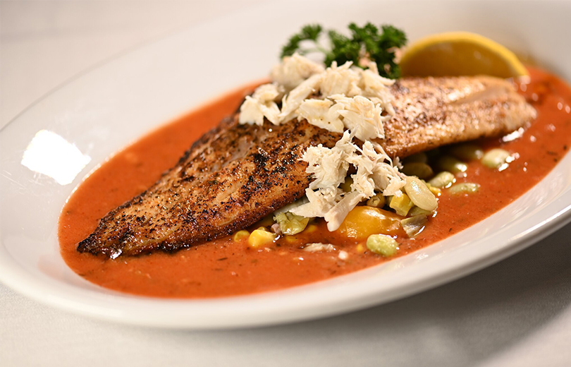 An authentic Creole dish with fish and a tomato-based sauce waits to be served at Dooky Chase's Restaurant in New Orleans.