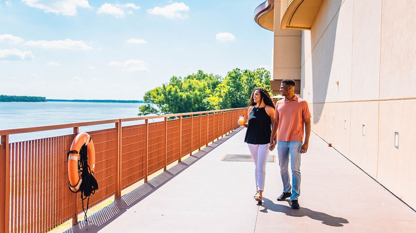 A couple walks by the Red River.