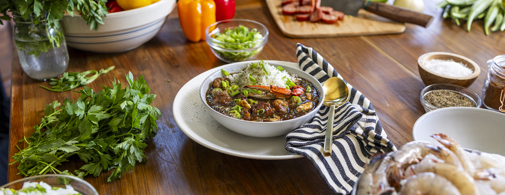 Bowl of Louisiana Seafood Gumbo surrounded by gumbo ingredients