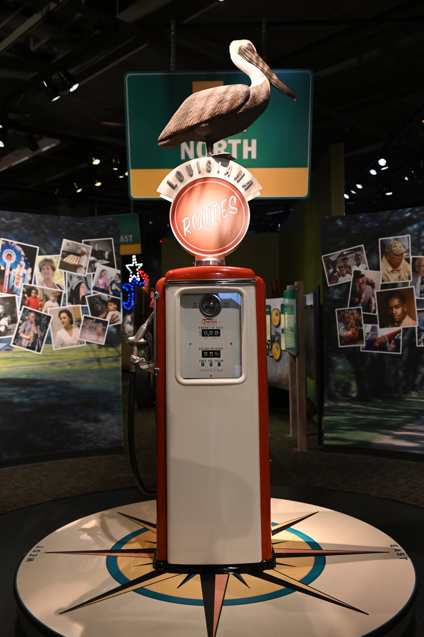 An exhibit at the Capitol Park Museum, featuring an old gas pump with a pelican sitting on top.