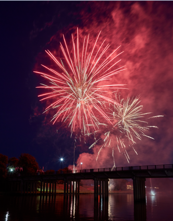 Red fireworks explode over the Cane River in Natchitoches, Louisiana.