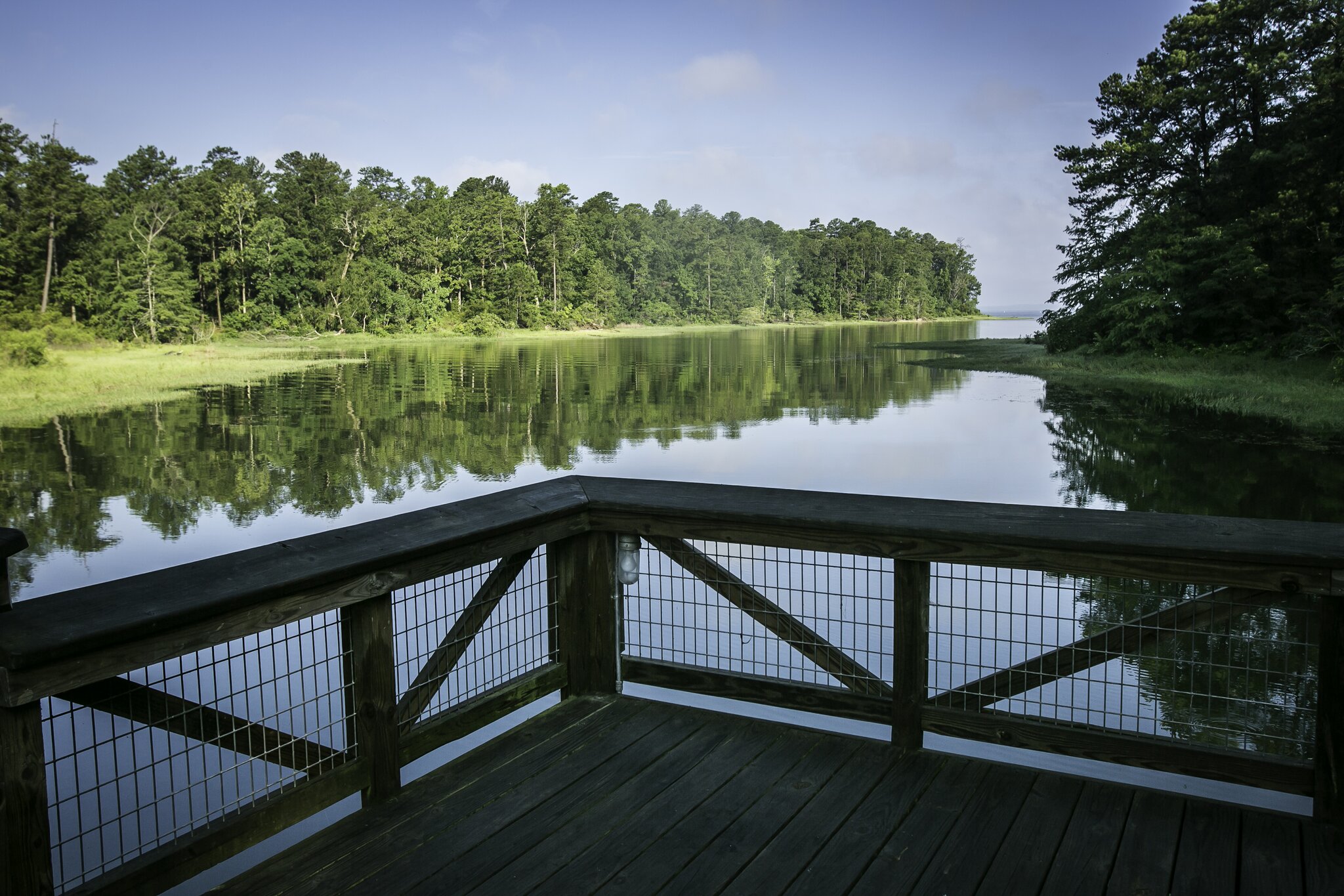 A wide wooden overlook faces a peaceful, tree-lined lake at South Toledo Bend State Park.