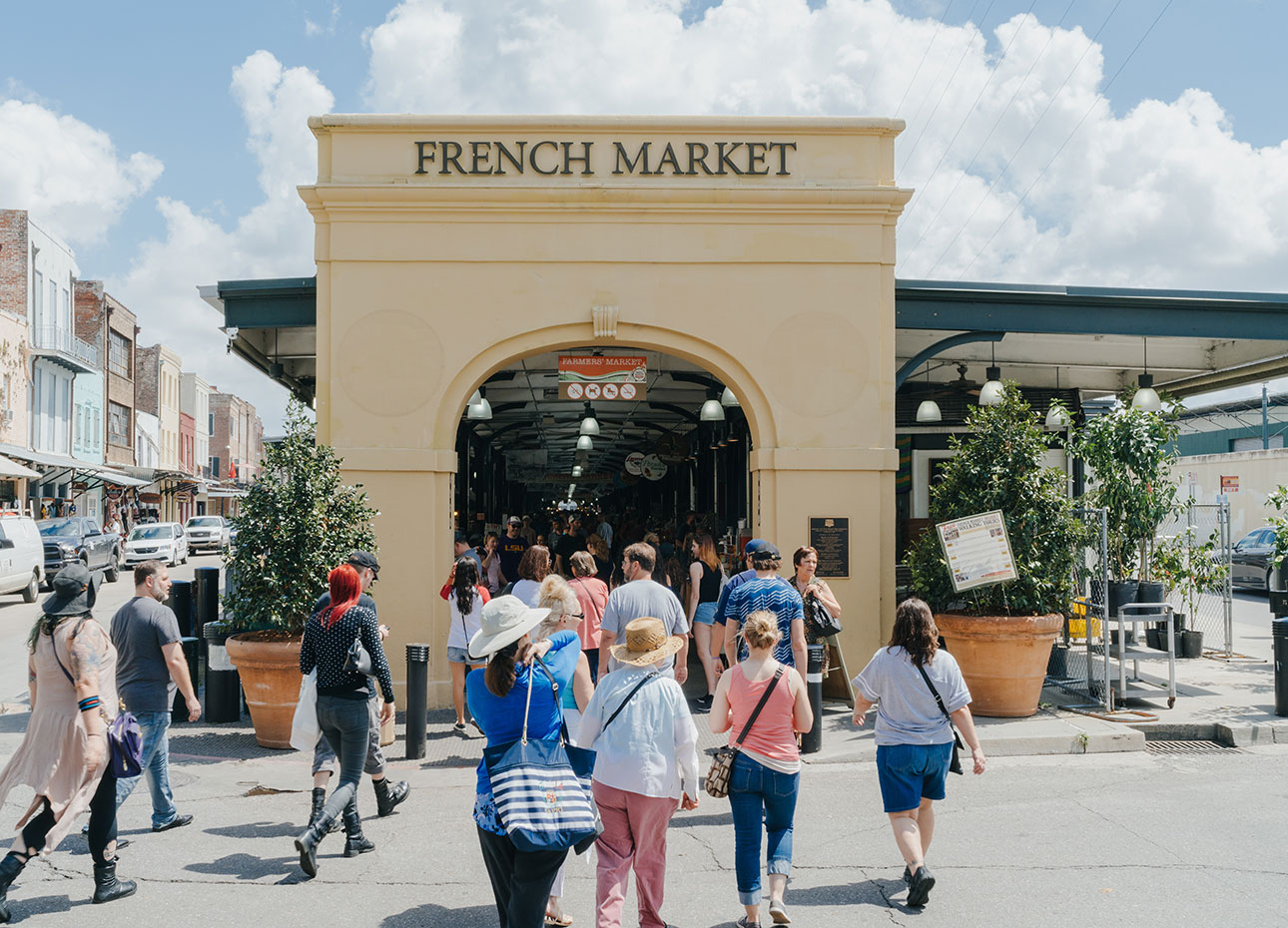 New Orleans historic French Market A large archway making the entrance to the French Market in New Orleans, Louisiana, surrounded by people shopping.