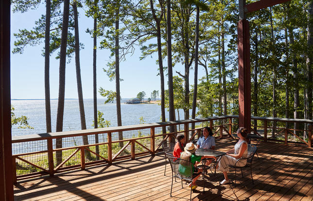 A family sits at a table on a wooden deck overlooking the reservoir at South Toledo Bend State Park.
