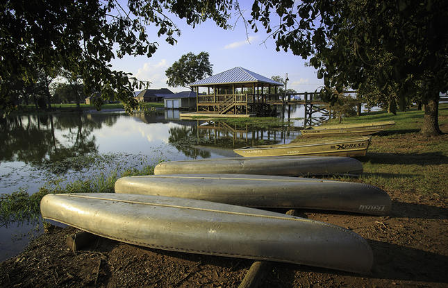 Canoes lined up on the shore at Poverty Point State Park.