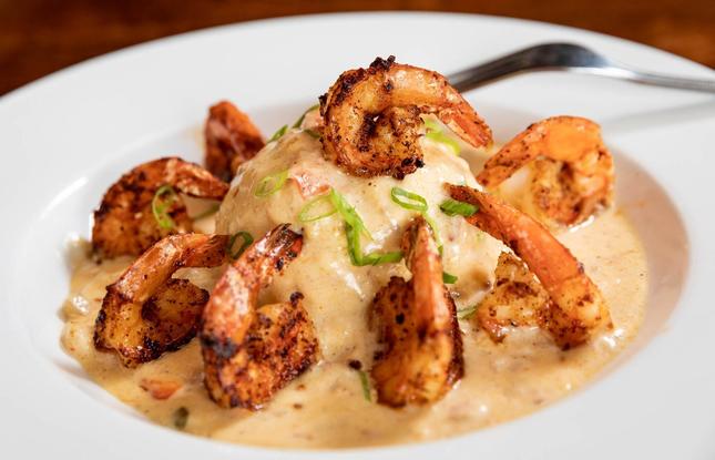 A plate of creamy grits topped with succulent Louisiana shrimp.