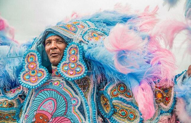 A Mardi Gras Indian wears a beautiful, elaborate blue costume at Jazz Fest.