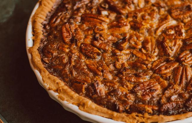 A deliciously golden pecan pie with crunchy pecans on top.