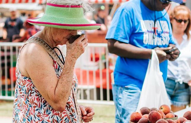People shop for peaches in downtown Ruston.
