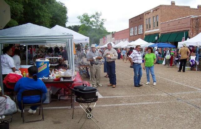 Vendors sit under tents during a downtown event