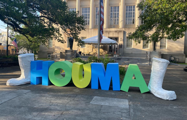 Letters spelling out Houma, with shrimp boots