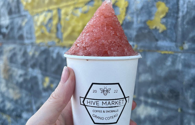 A person holds a strawberry snowball