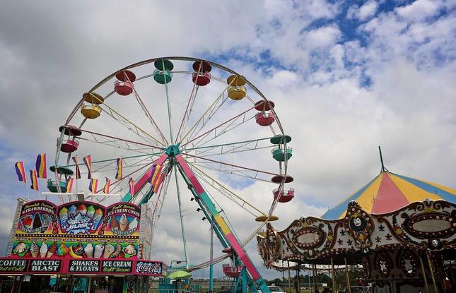 A ferris wheel, carousel and fair food stand are pictured during the street fair at the  Louisiana Sugar Festival.