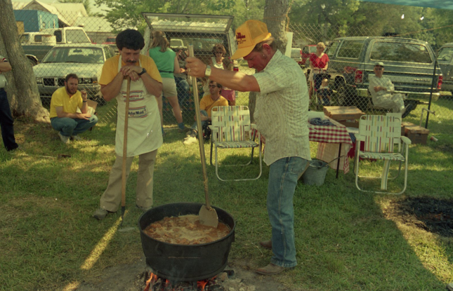 A team of cooks stir a giant pot of jambalaya in the 1986 Jambalaya Festival in Gonzales, Louisiana.