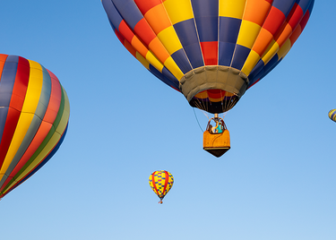 Hot air balloons ascend.