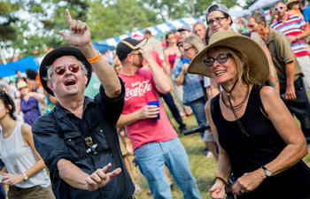 Two people dance among a crowd. 