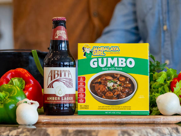 Abita Beer, gumbo mix and fresh ingredients on stove top