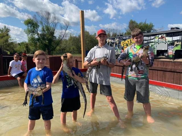 Kids holding alligators