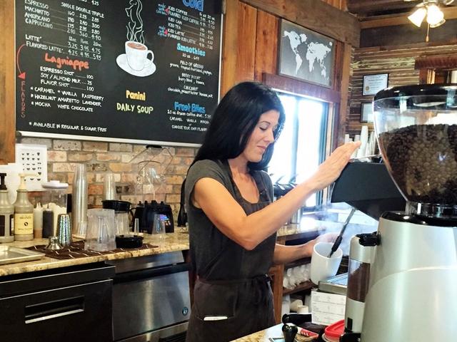 Giddy Up owner Ashley Belanger makes a customer's coffee.