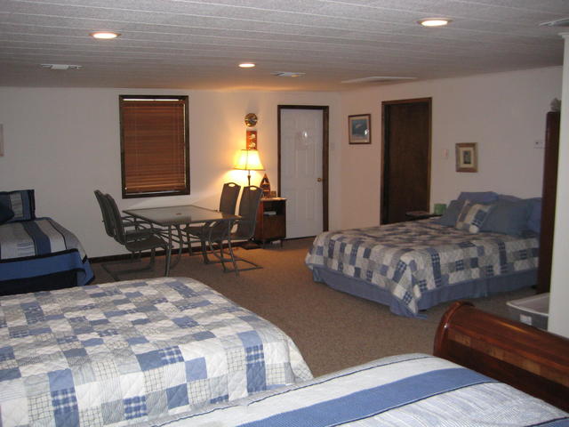 The "Bunk House" has covered parking, a covered picnic area, 2 TV's, a fully furnished kitchen, and four queen sized beds.  You don't share this with strangers, it is just for your group or family.