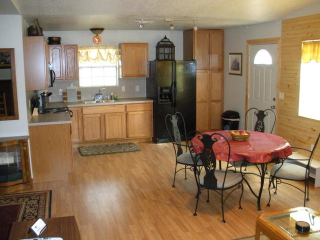 This is the kitchen area of the cabin, the kitchen is fully stocked including a micro-wave, coffee pot, toaster, etc