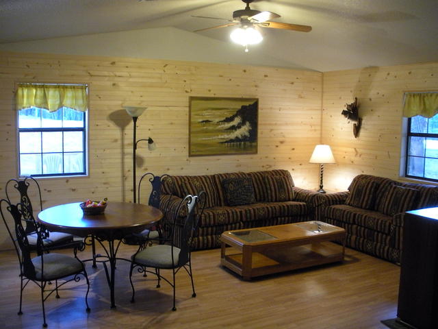 This is a view of the cabin's main living area, the pine accent walls gives it a cabin feeling but you won't be roughing it here, also includes a TV area, and dining area.