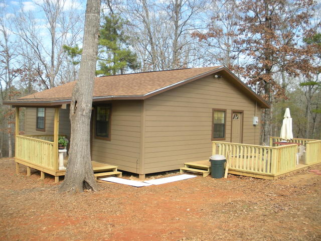 The cabin is nearly 900 sq ft and is two bedroom/one bath with a covered porch and a side deck.