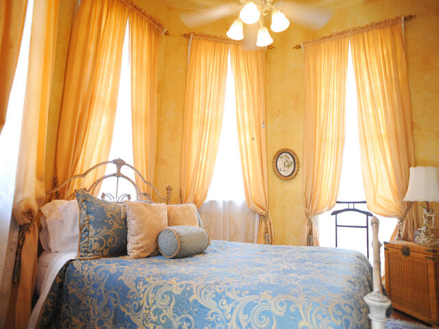 The Solarium Suite features a queen bed nestled into a cozy alcove just off the main sitting room.