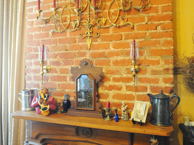 The house retains many of its original architectural elements, like the kitchen fireplace and hearth.