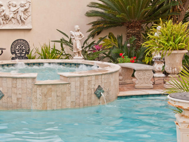 Relax in our Roman-styled hot tub and pool set in a lush tropical garden