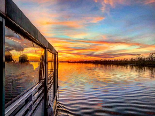 A beautiful sunset over the bayou with a booze cruise.