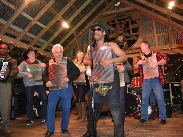 Band on stage inside barn