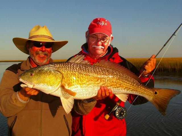 Capt. Marty Authement (left) with flyfishing client Bill May of Maryland and a bruiser of a redfish caught in the shallow-water marsh of Terrebonne Parish.