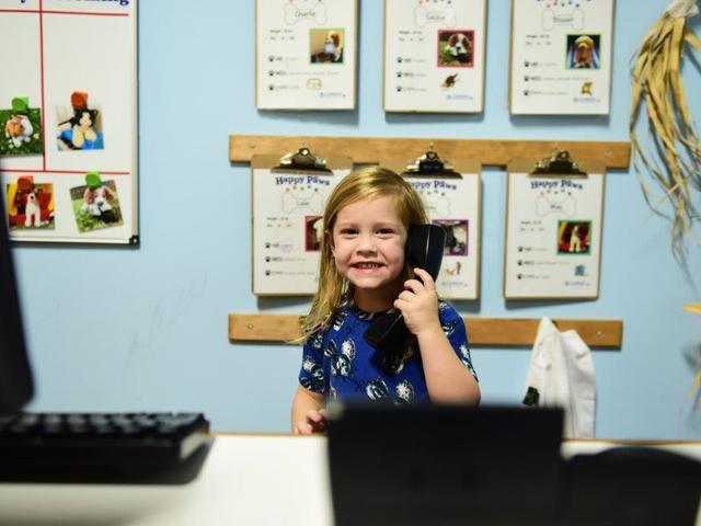 A future vet plays in the Happy Paws Animal Hospital.