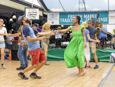 A couple dances at the jazz stage during the French Quarter Fest in New Orleans.