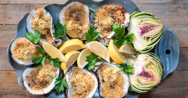 Chargrilled Oysters with Artichoke Garlic Cream Sauce | Explore Louisiana