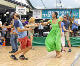 A couple dances at the jazz stage during the French Quarter Fest in New Orleans.