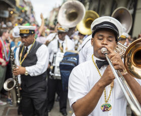 Enjoy second lines and jazz music during Mardi Gras parades.