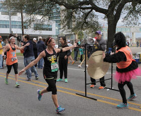 A person crosses the finish line of the Zydeco Marathon.