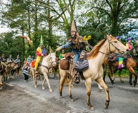 Courir de Mardi Gras participants ride on horseback through Eunice, Louisiana.