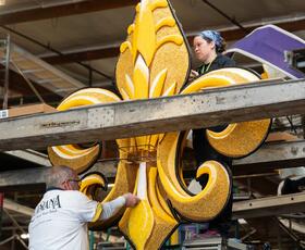 Float volunteers decorate Explore Louisiana float for the Rose Parade.