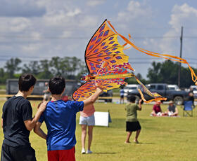 Brothers flying a butterfly kite at Kite Fest Lousiane'.
