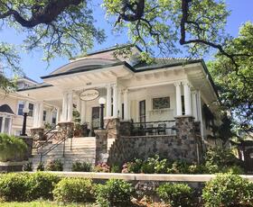 The exterior of Canal Street Inn on a sunny day in New Orleans.