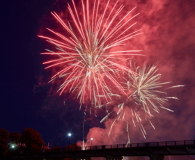 Red fireworks explode over the Cane River in Natchitoches, Louisiana.