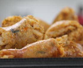 Fresh, glimmering boudin, cut open to reveal the meat-and-rice filling inside.