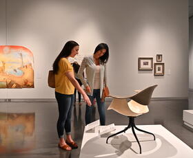 Two people view an installation at Shaw Center for the Arts.